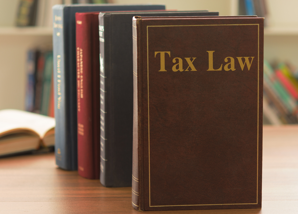 Tax law books standing upright on desk