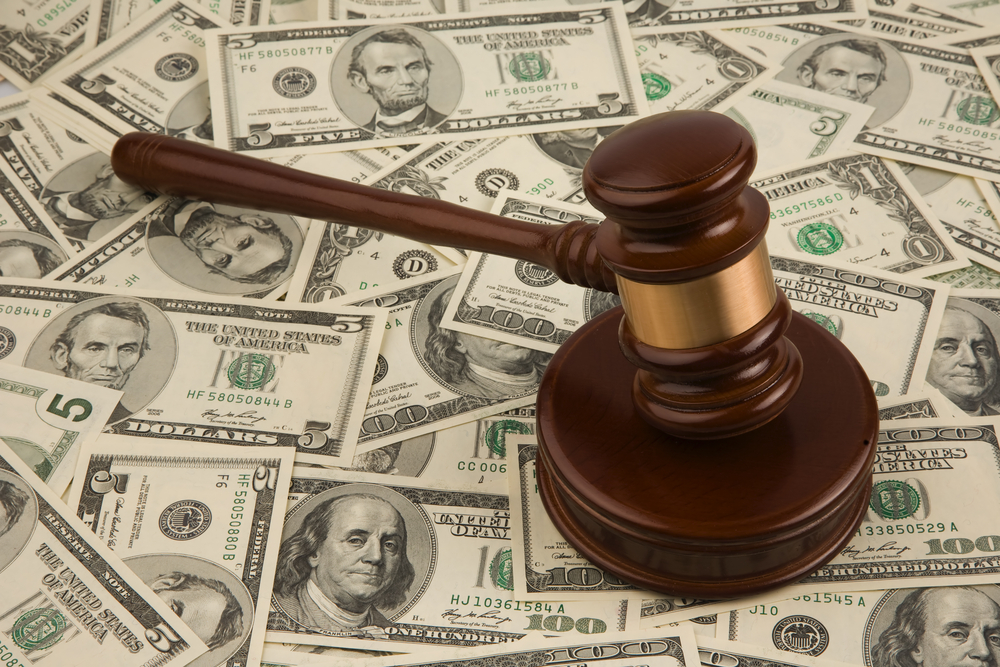 Judge gavel on pile of cash