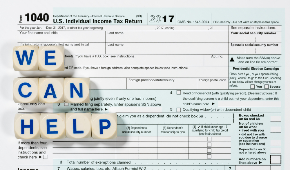 Cubes spelling "we can help" on tax form 1040