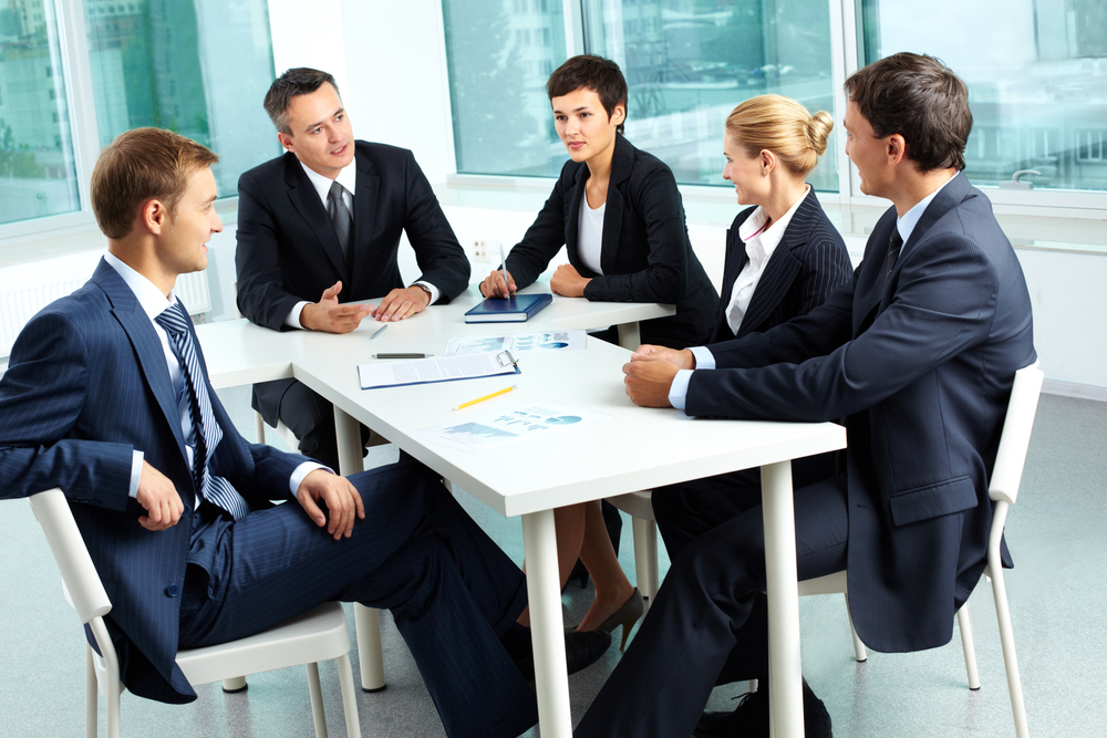 Business professionals around conference table