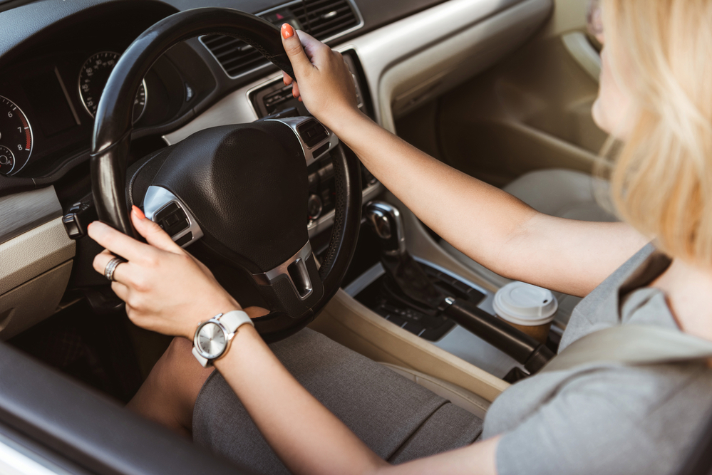 Businesswoman behind wheel of car