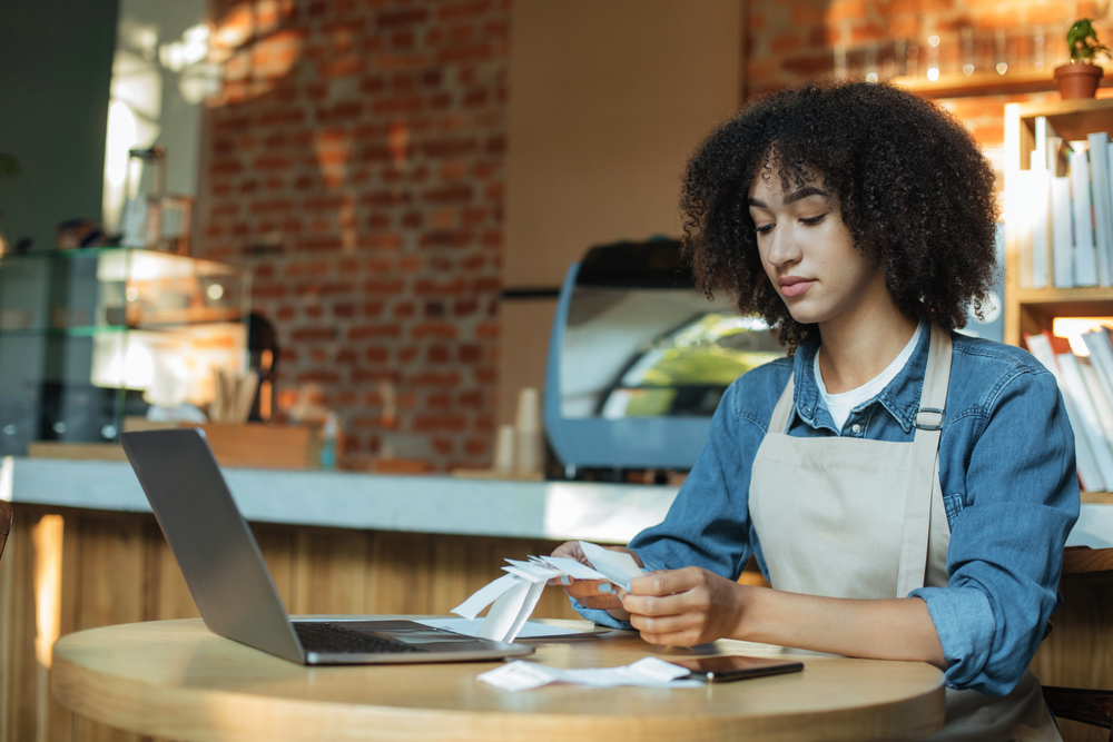 Woman in bakery going over financial documents