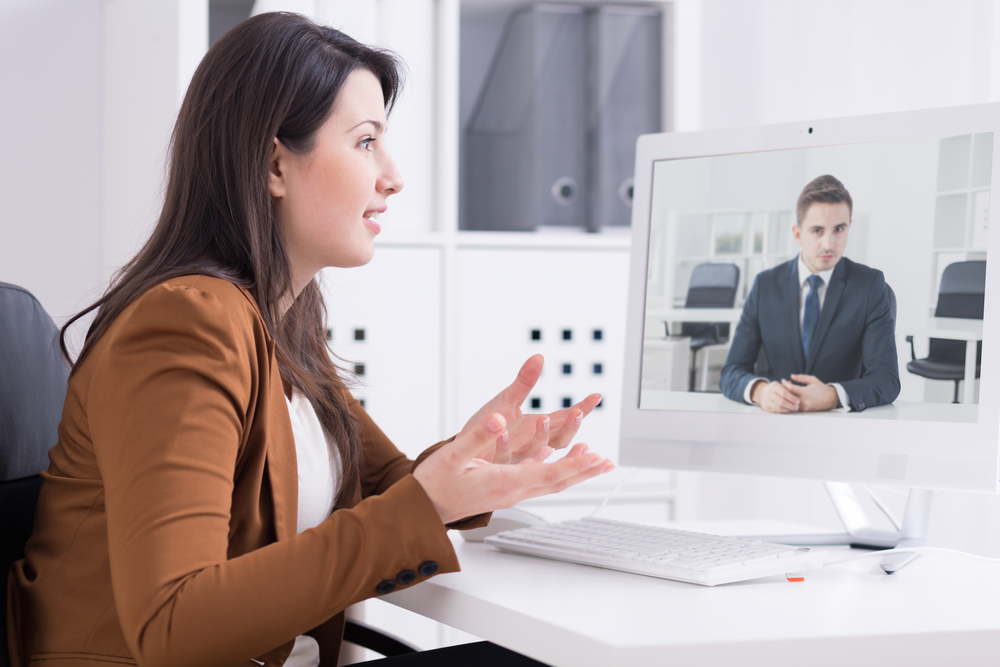 Woman in a virtual meeting with man in a business suit