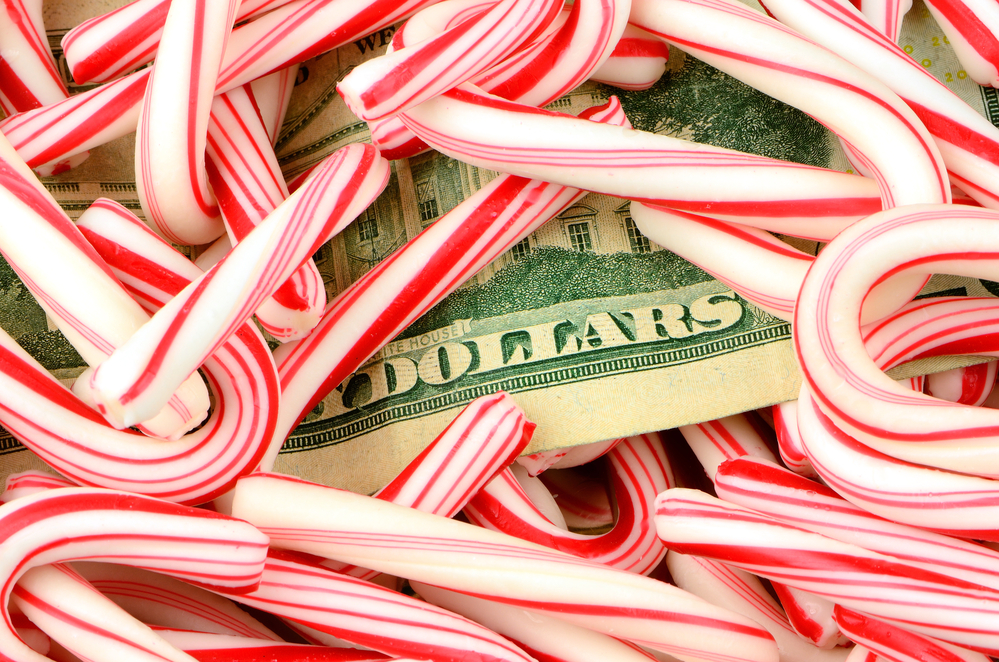 Dollar bill under pile of candy canes