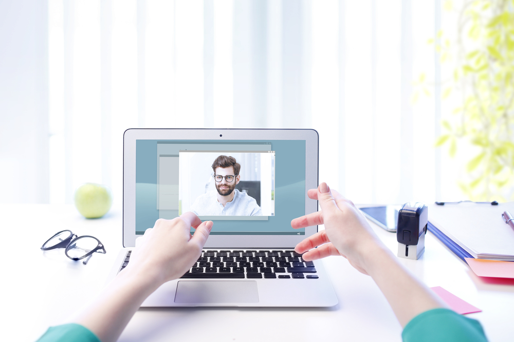 Woman video chatting man on computer